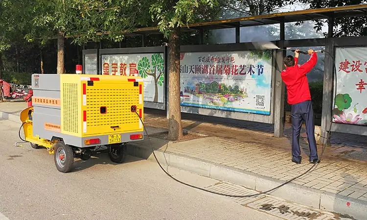 A high-pressure cleaner is washing a bus stop sign