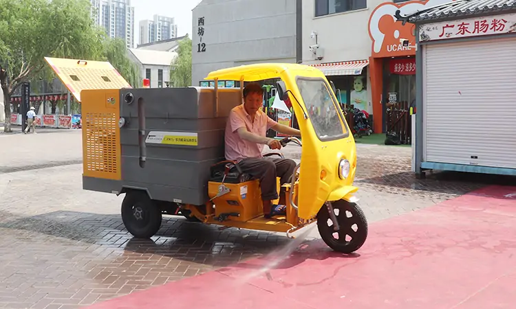 Small Three-wheeled Road Cleaning Vehicle Washes Commercial Pedestrian Streets