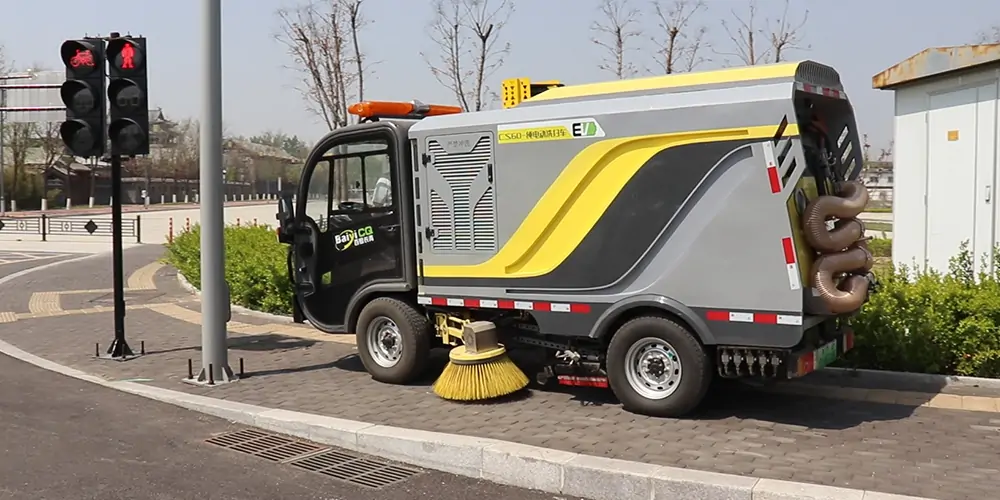 A Small Electric Street Sweeper Is Used For Cleaning And Maintenance In A Park