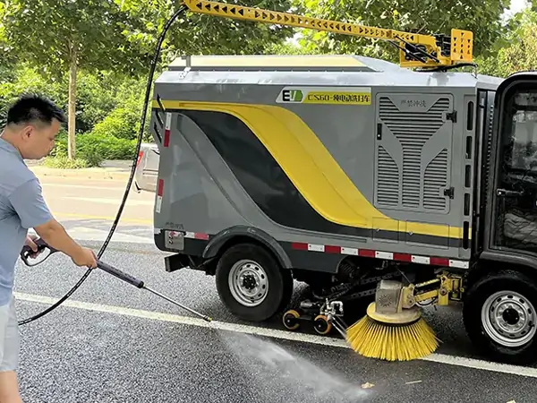 Small Electric Street Sweeper Is Used For Cleaning And Maintenance In A Park