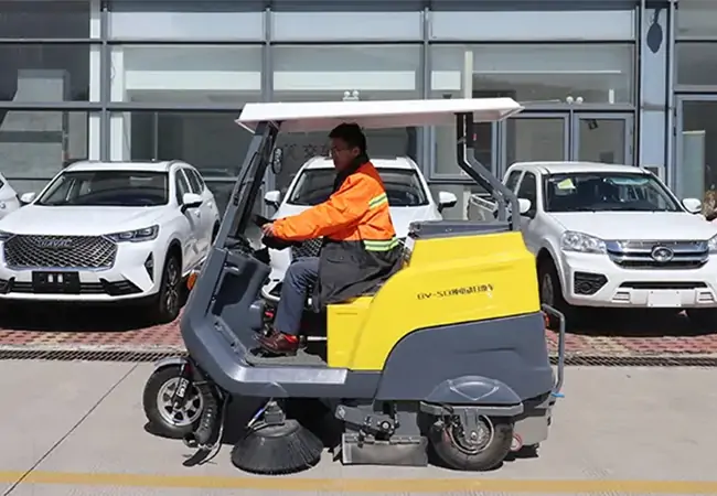 A small electric street sweeper Baiyi-S13 cleans the car plaza